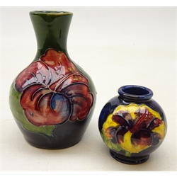  Moorcroft vase of bottle shaped form tube lined in the 'Hibiscus' pattern H9cm and a Moorcroft 'Hibiscus' miniature globular vase (2)  