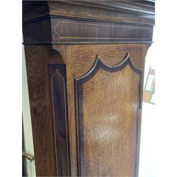 Early 19th century oak and rosewood banded longcase clock, scrolled pediment over stepped arch hood door, enamel painted dial indistinctly signed for a Penrith maker, 30-hour movement striking on bell