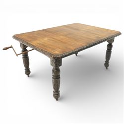 19th century heavily carved oak extending dining table, with winding mechanism and a gadrooned edge, over block and turned supports terminating in castors, extends to 147cm