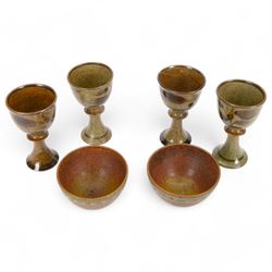 David Lloyd Jones (1928-1994): set of four studio pottery goblets, with foliate decoration on a mottled brown ground, together with two small stoneware bowls by the same artist, with stylised bird border on an orange brown ground, all with impressed marks beneath, goblets H15.5cm