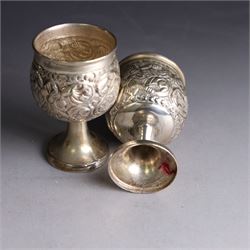 Pair of miniature Indian silver goblets, with embossed floral and foliate decoration, H6.5cm