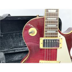 1980s Les Paul Epiphone limited edition cut-away electric guitar by Gibson, the burgundy coloured body with two pick-ups, volume and tone knobs and scratch plate, original tuning pegs, serial no.U6030215, 101cm overall; in modern Kinsman fitted carrying case