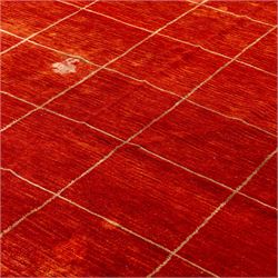 Two contemporary Moroccan Berber hand-woven rugs, deep madder red field of plain design, 199x153cm, other with deep madder red field with a simple lattice of ivory lines forming panels with some tonal variation, 190x146cm 