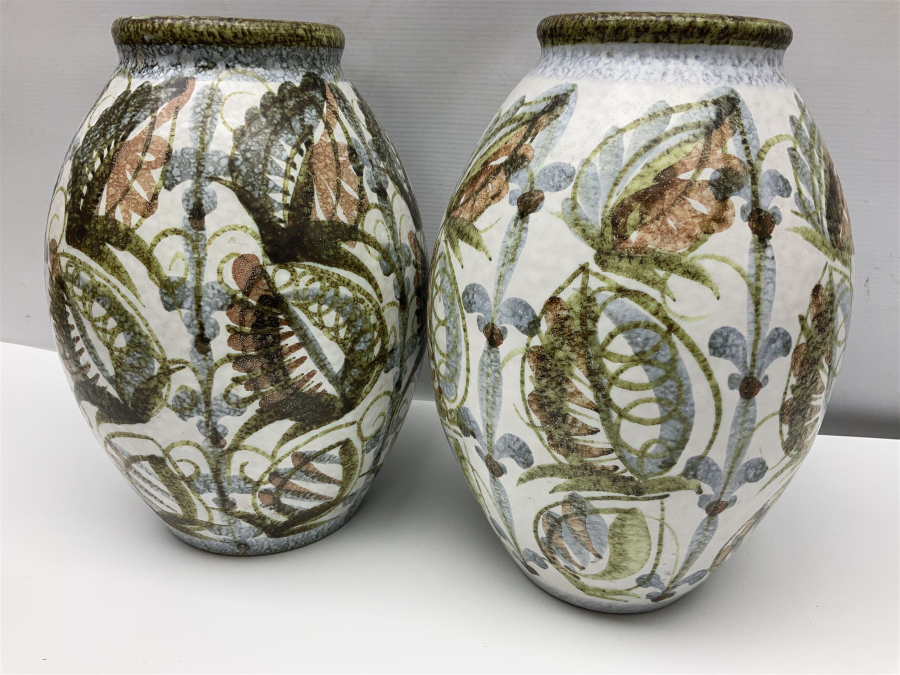 Pair of Denby Glyn Colledge stoneware vases of ovoid form with floral decoration over cream ground, together with a large bowl in a similar design, vases H32cm