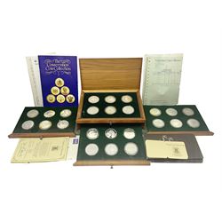 The Royal Mint 'Conservation Coin Collection' formed of twenty-four silver proof coins, housed in the wooden display case, with information booklet