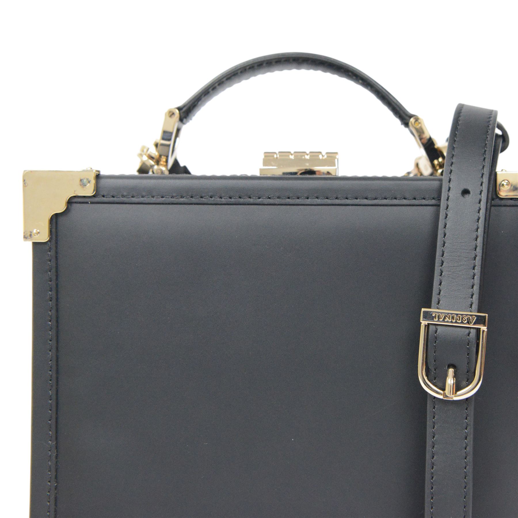 Aspinal of London black leather structured top-handle handbag with gold-tone metal mounts and corner protectors, the hinged lid opening to a fabric-lined interior fitted with a zip pocket and slip compartment, leather brand label stamped Aspinal of London England, fitted with a detachable adjustable leather shoulder strap, accompanied by an Aspinal of London dust bag and presentation box, W19cm D8cm H16cm