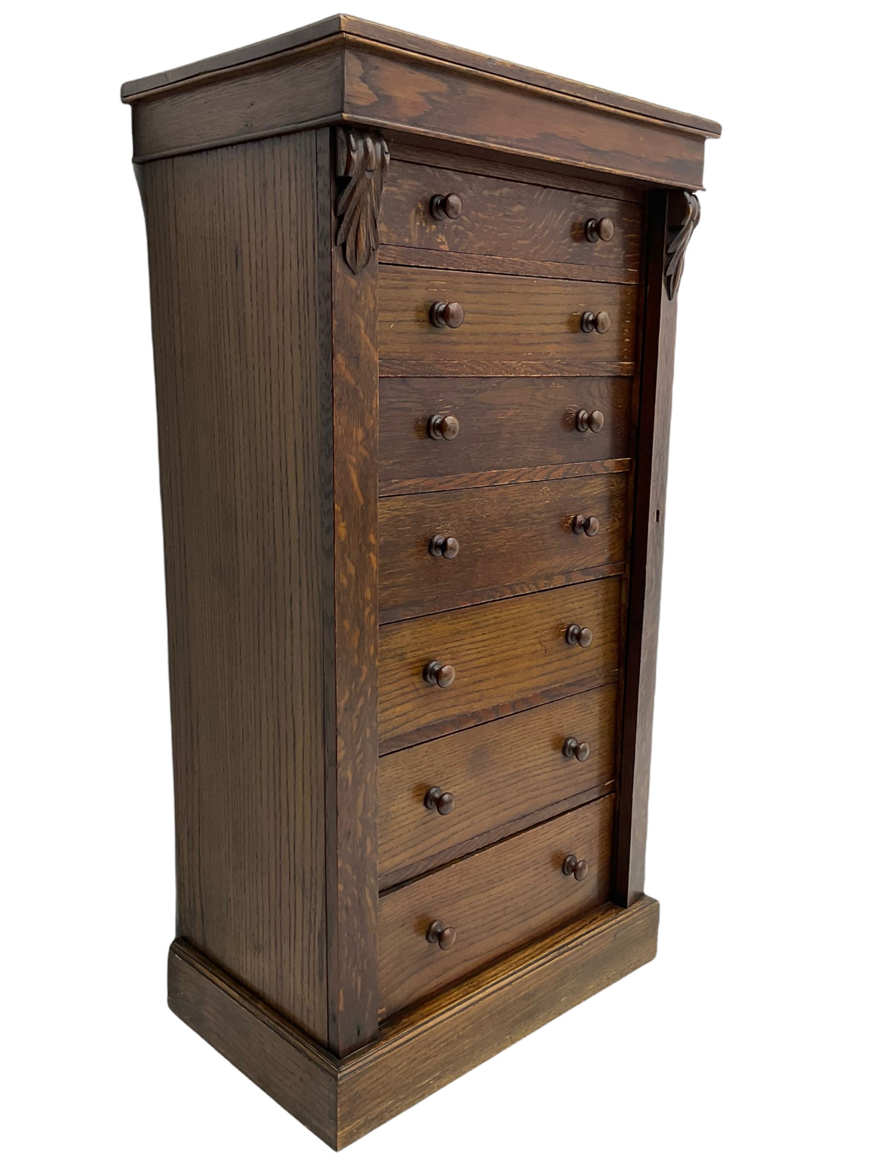 Victorian oak Wellington chest, fitted with seven drawers, lockable hinged side return