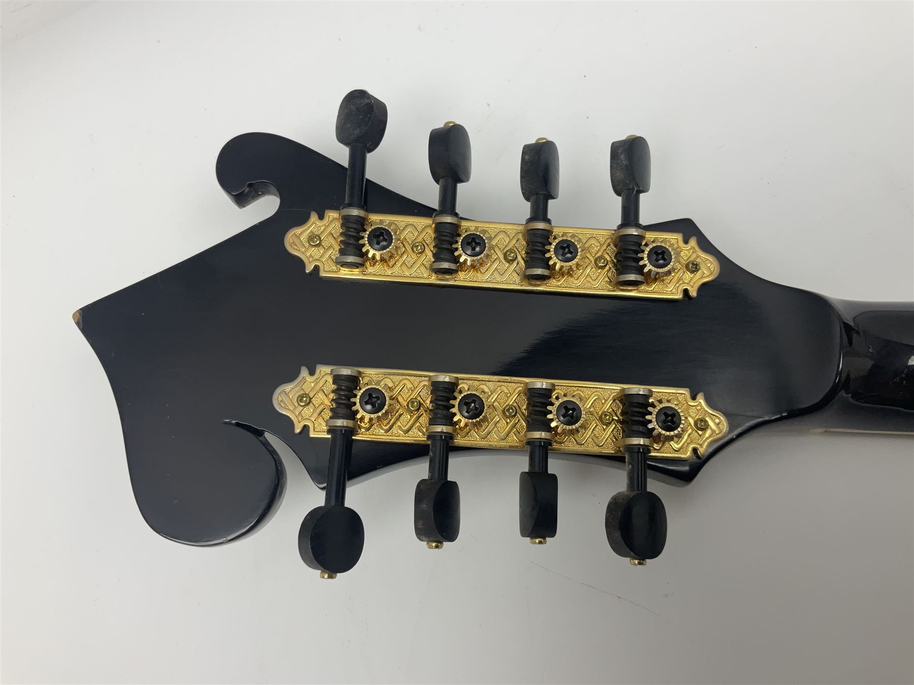 Eastern F-hole eight-string mandolin with black finish and mother-of-pearl inlay of a man riding a winged horse/unicorn amongst clouds and stars with playing card suits to the fingerboard L71cm