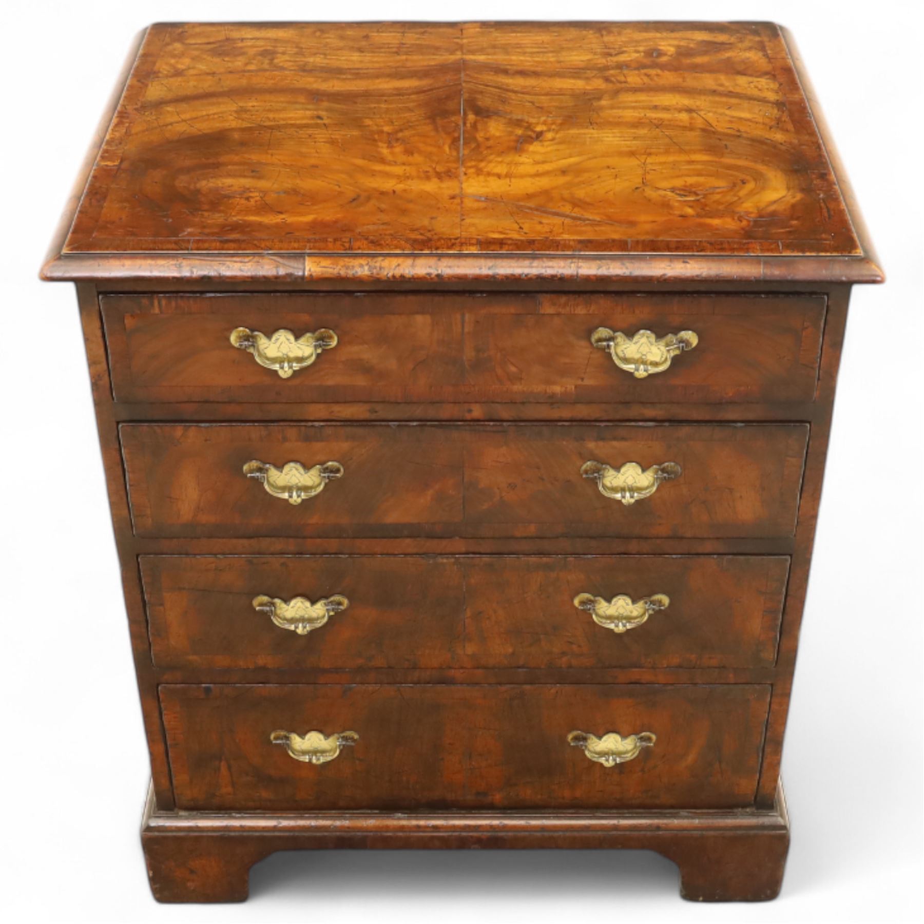 Small 19th century figured walnut chest of drawers, rectangular top with moulded edge over four graduating drawers with brass batwing handles, raised on bracket feet