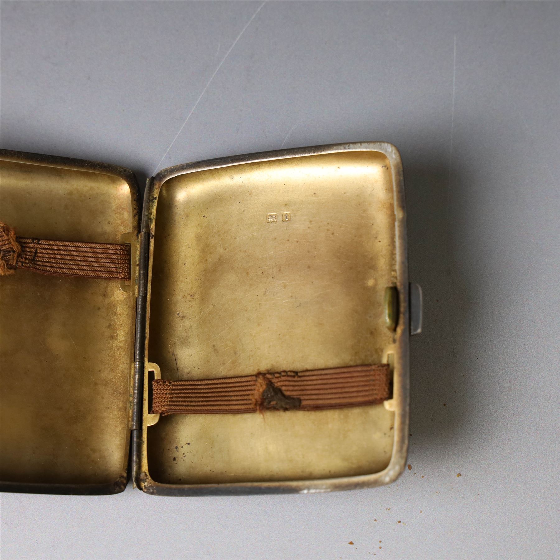 1960s silver compact mirror, of circular form with engine turned and engraved foliate decoration to lid, hallmarked Kigu Ltd, London 1963 and an early 20th century silver cigarette case with engraved monogram to cover, hallmarked A J Pepper & Co, Birmingham 1918
