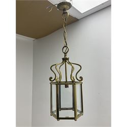 Two Regency style brass vestibule or hall lanterns, glazed hexagonal form with scrolled supports, largest H70cm
