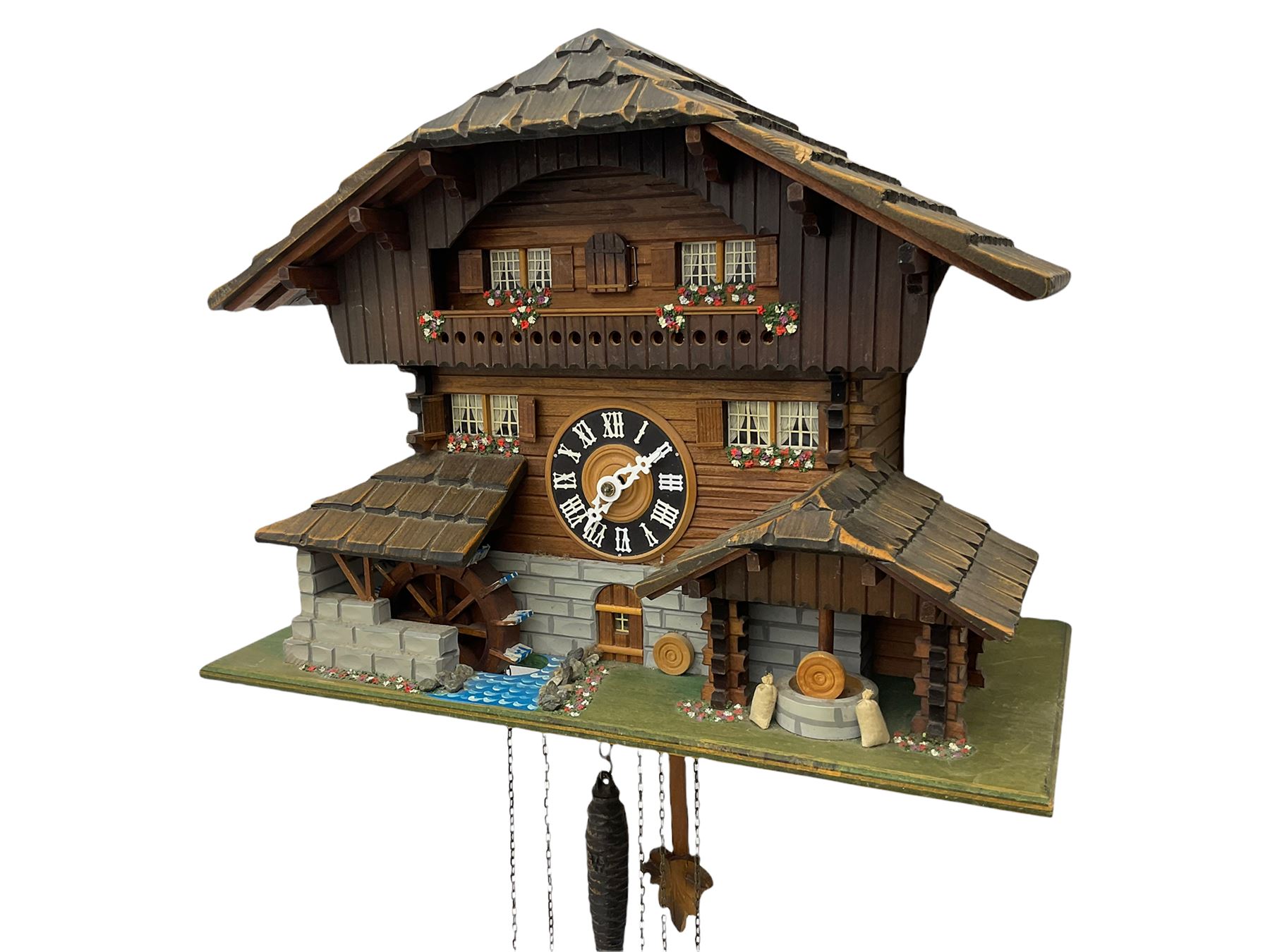 An automaton musical cuckoo clock with a 20th century three weight movement in the form of a Swiss Chalet with a working waterwheel, traditional dial and hands, thirty-hour movement with a cuckoo sounding the hours and half hours on twin bellows, hours followed by one of three tunes played on a musical box and the revolving of the water wheel. With pendulum and weights.




