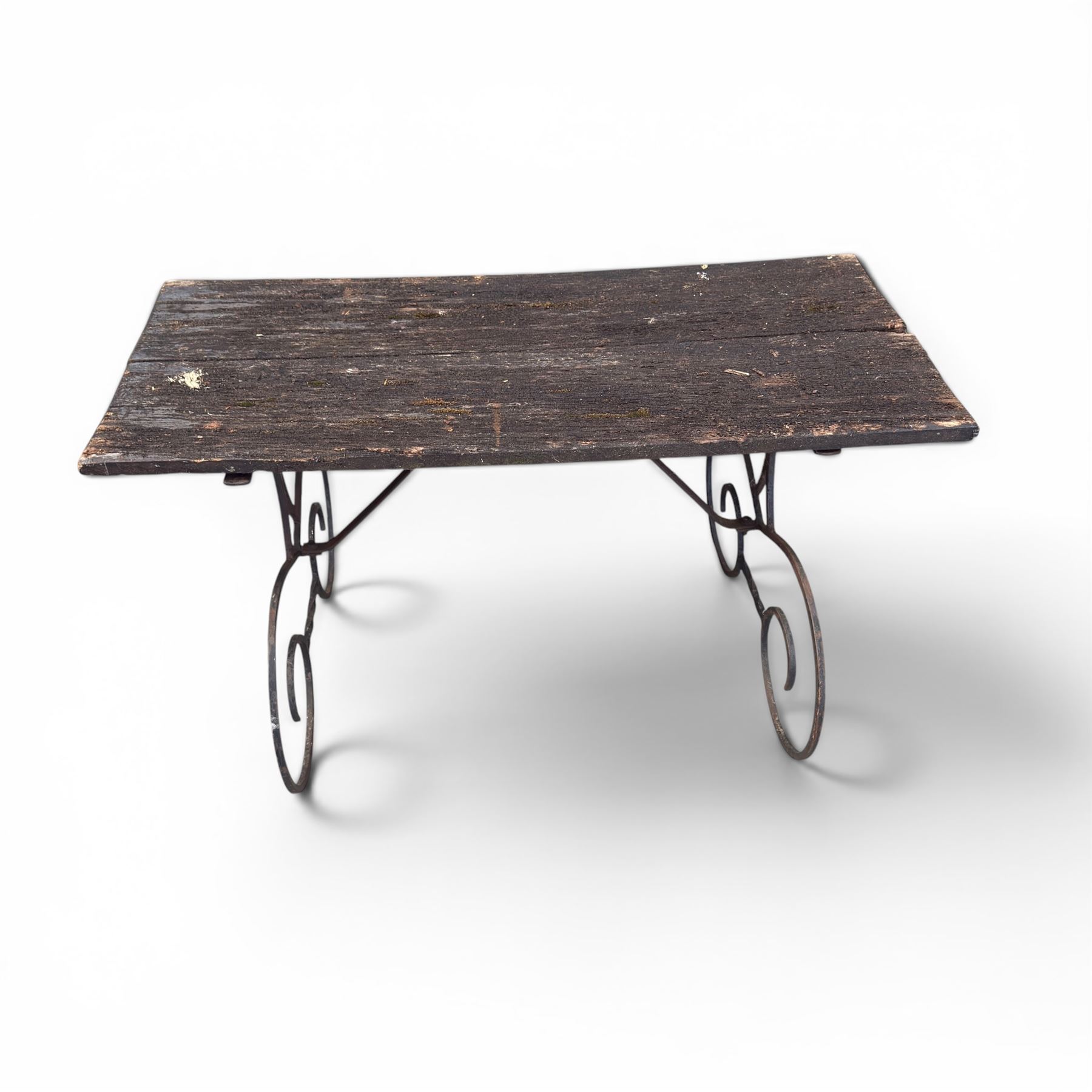 Cast iron garden table, with rectangular weathered slatted wooden top, raised on iron strapwork supports of scrolling form, in black painted antique finish 