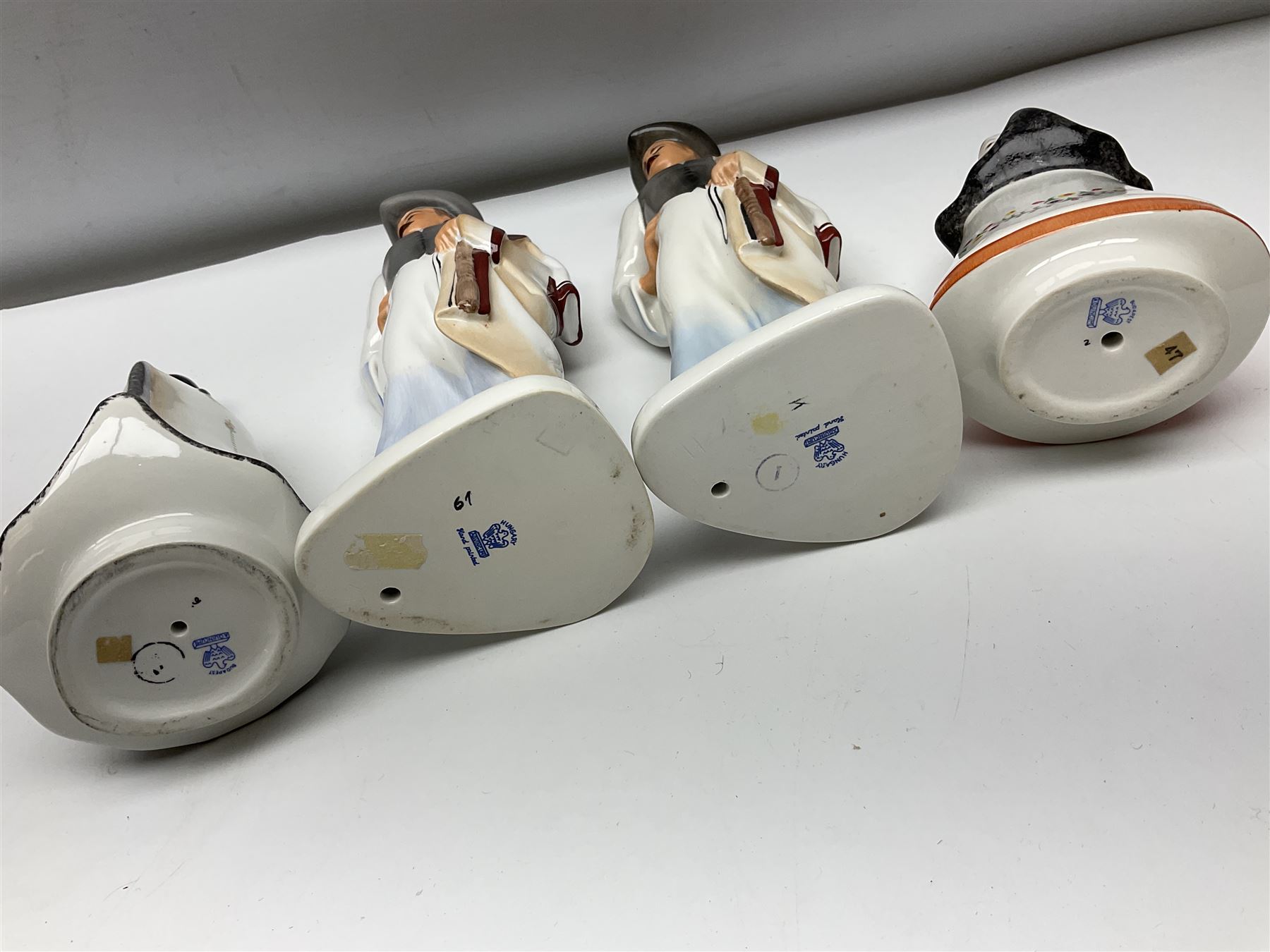 Group of eleven Aquincum of Budapest figures, comprising two of a man in a feather hat, seven dwarves, man and woman in traditional dress, all with printed marks beneath