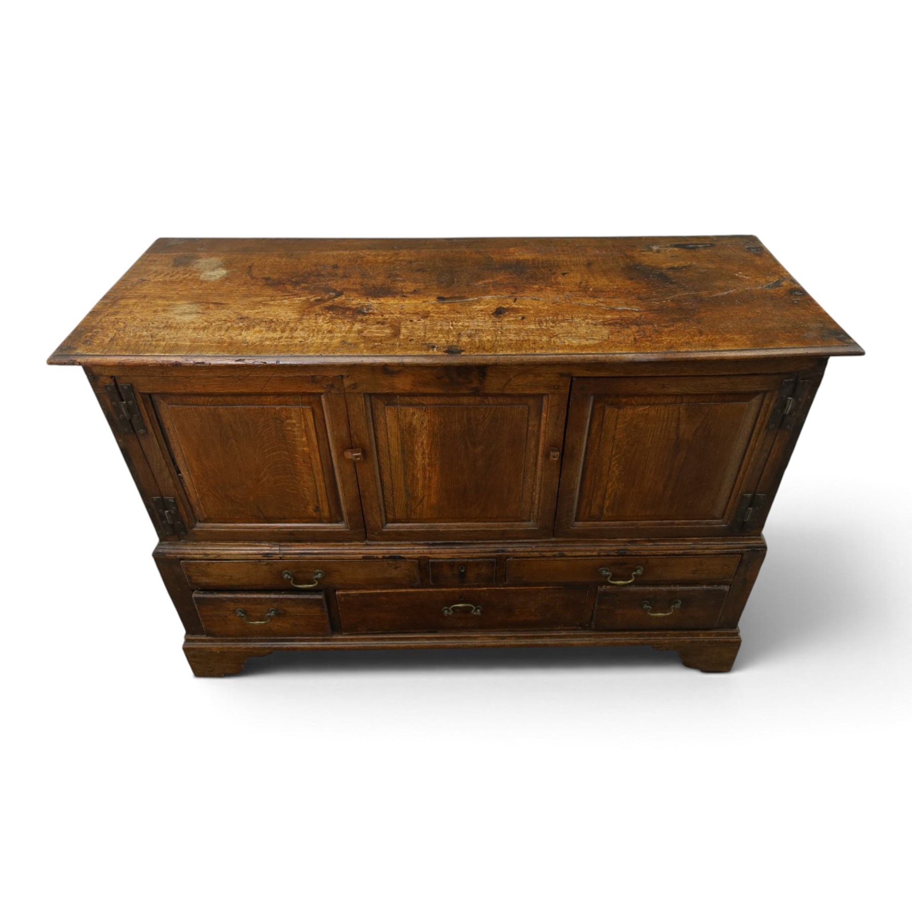 18th century oak hall cupboard, rectangular top with moulded edge, over two panelled hutch-cupboards, the base fitted with six assorted drawers, on large bracket feet
