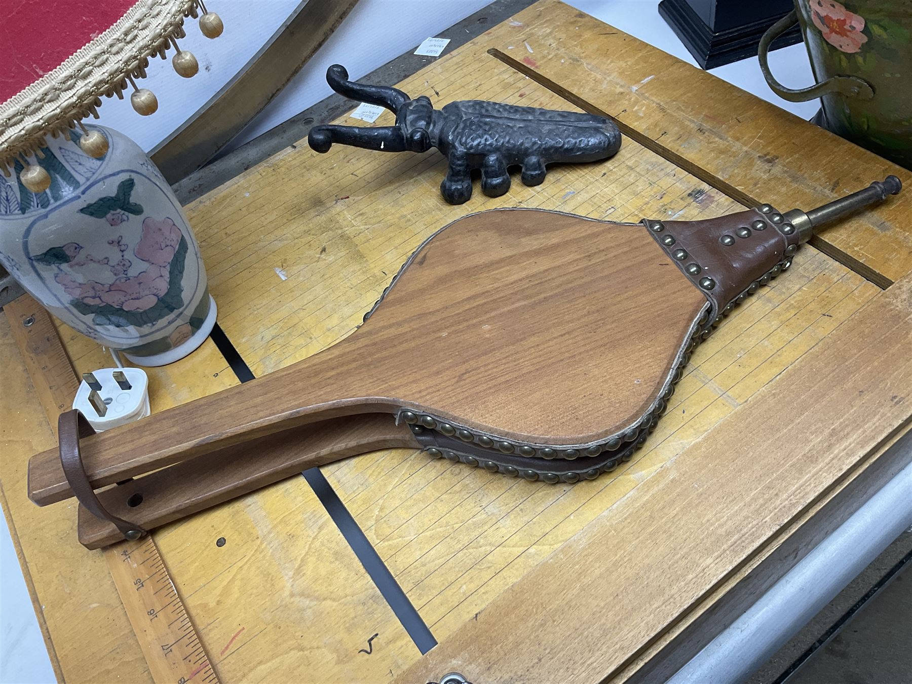 Coal bucket painted with flowers together with pair of bellows, boot scraper in the form of a beetle, wooden guillotine, composite table lamp with tassel lampshade and one other