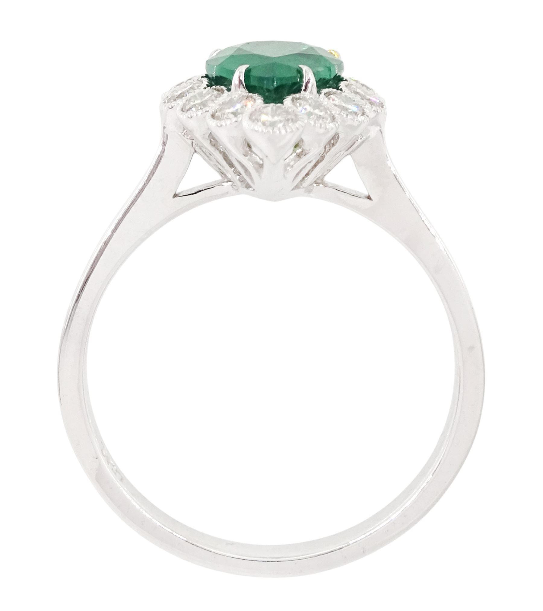 18ct white gold emerald and diamond cluster ring, single pear cut emerald of approx 1.40 carat, surrounded by twelve round brilliant cut diamonds, in a milgrain setting, stamped 750, total diamond weight approx 0.55 carat