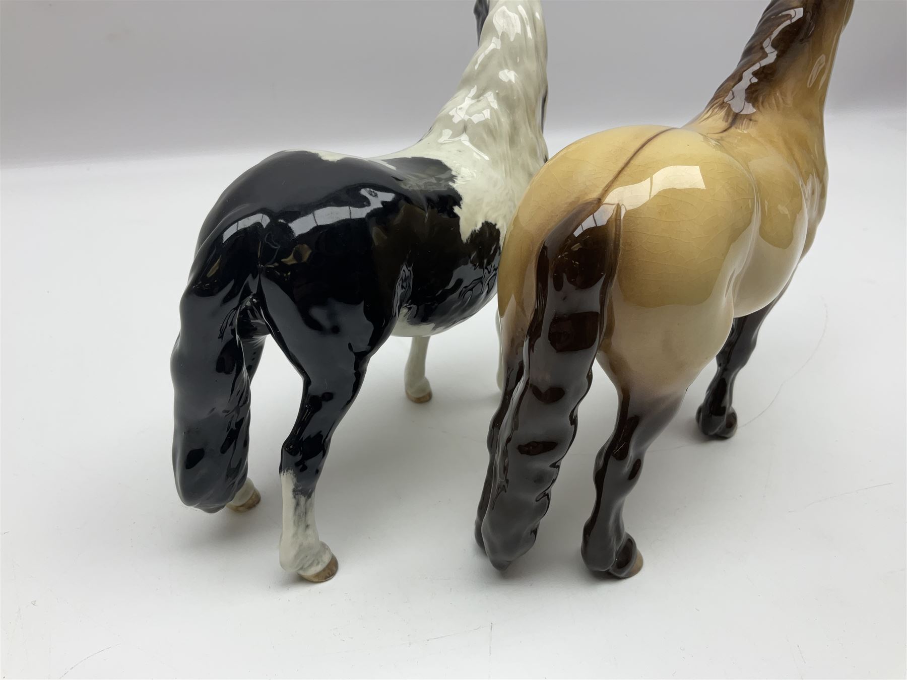Beswick dun Highland pony no 1644 and piebald Pinto Pony  no 1373, both with printed mark beneath
