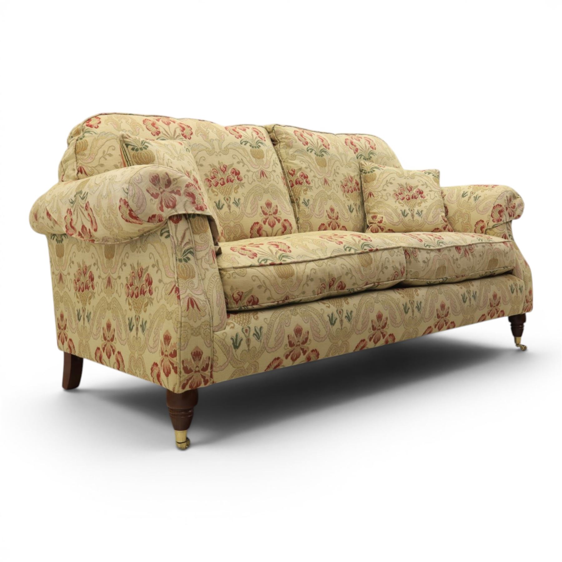 Parker Knoll - 'Henley' floral fabric living room suite, comprising a two seat sofa and pair of armchairs, raised on dark stained turned feet raised on brass castors

Armchairs (H 99cm, W 95cm, D 100cm)