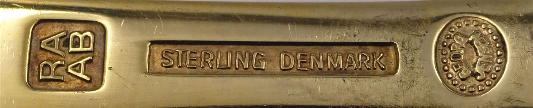 Five Danish silver-gilt year spoons by Georg Jensen, each decorated with different floral motif including sunflower, forget-me-not and shamrock, dated between 1973 and 1983, each impressed on underside RA AB, Sterling Denmark, and marked for Georg Jensen, approximate gross weight 7.3ozt (227 grams)