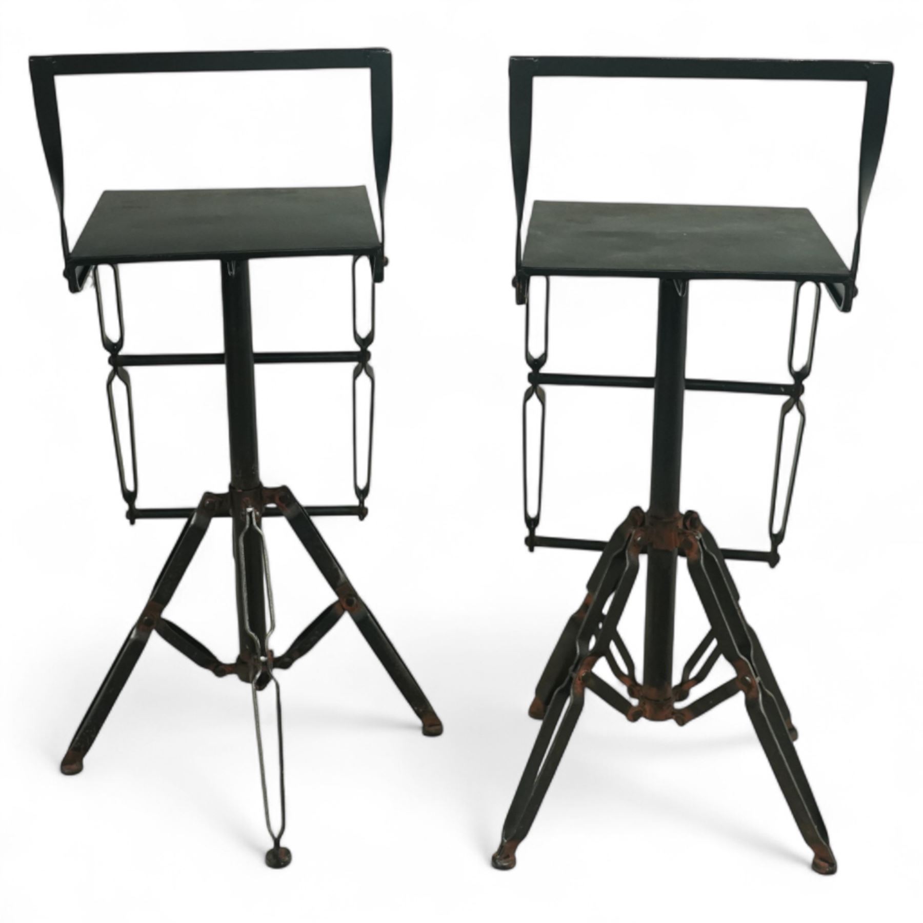 Pair of 20th century brutalist industrial metal swivel bar stools, sheet seats with strap backrests with bolted design to the sides, raised on quadripod bases with angular strut supports, the seats height-adjustable and swivelling
