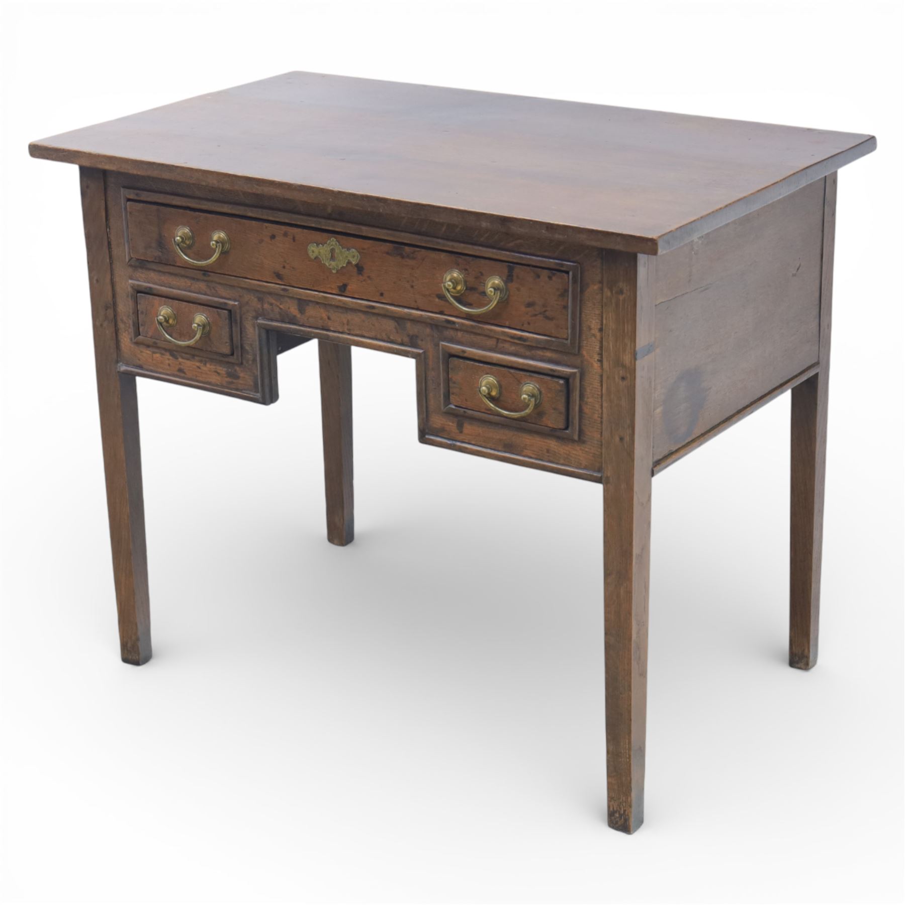 18th century oak lowboy, the rectangular top above an arrangement of three drawers with brass swan neck handles and shaped backplates, the drawers with fielded fronts, raised upon square tapering legs 