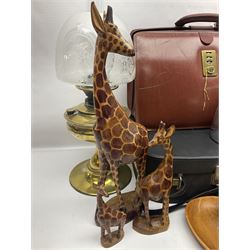 Brass oil lamp, with etched floral glass shade, leather Gladstone style doctors bag, leather satchel and vintage vanity case, three graduating wooden giraffes and other wood and metal ware, lamp H54cm