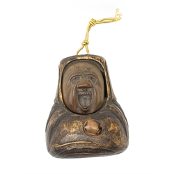 A Japanese carved soft wood inro, modelled as an open mouthed figured and with inset glass eyes, H8.5cm. 