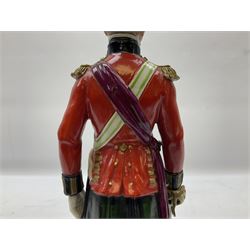 Sitzendorf figure, The Black Watch officer, c1815 standing to attention in full dress with sword, blue factory marks beneath, H28cm