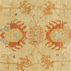 Cream ground prayer rug, with red and blue stylised motifs within a broad floral border, the field with central mihrab-style design in soft red, blue and beige tones