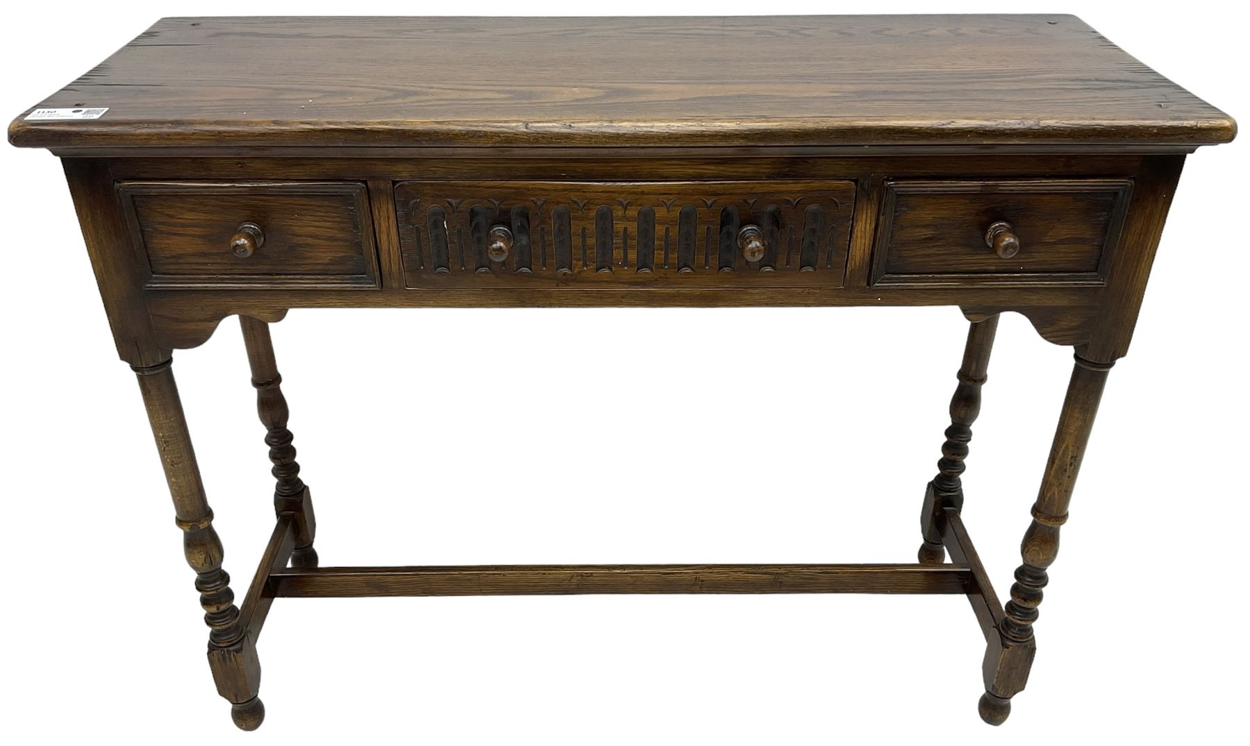 Medium oak side table, rectangular top over three drawers, on turned supports united by H-shaped stretcher rails 