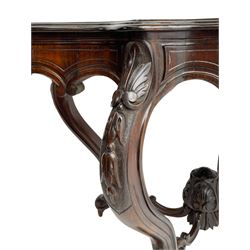 19th century Irish rosewood centre table, the shaped and moulded top over shaped apron carved with scrolled foliage, on serpentine supports carved with bell flowers, the supports united by anthemion carved finial and s-scroll x-framed stretchers