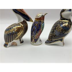 Three Royal Crown Derby paperweights, comprising Brown Pelican, Puffin and Humming bird, all with gold stoppers and printed marks beneath, largest H13cm