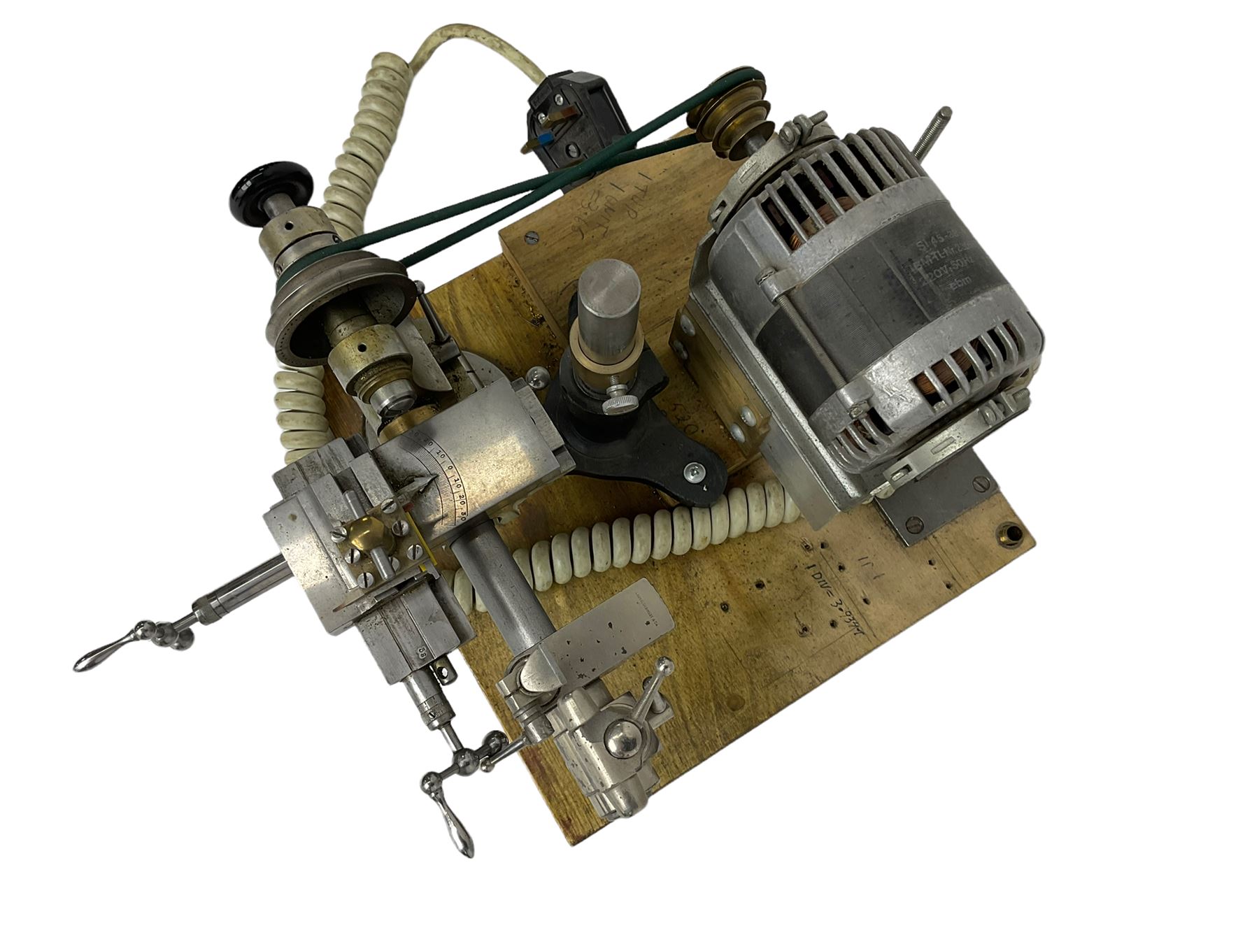 Lorch 6mm watchmakers lathe with tailstock, crosslide, tool rest, four-way tool post, pulleys and motor. Mounted on a wooden board.