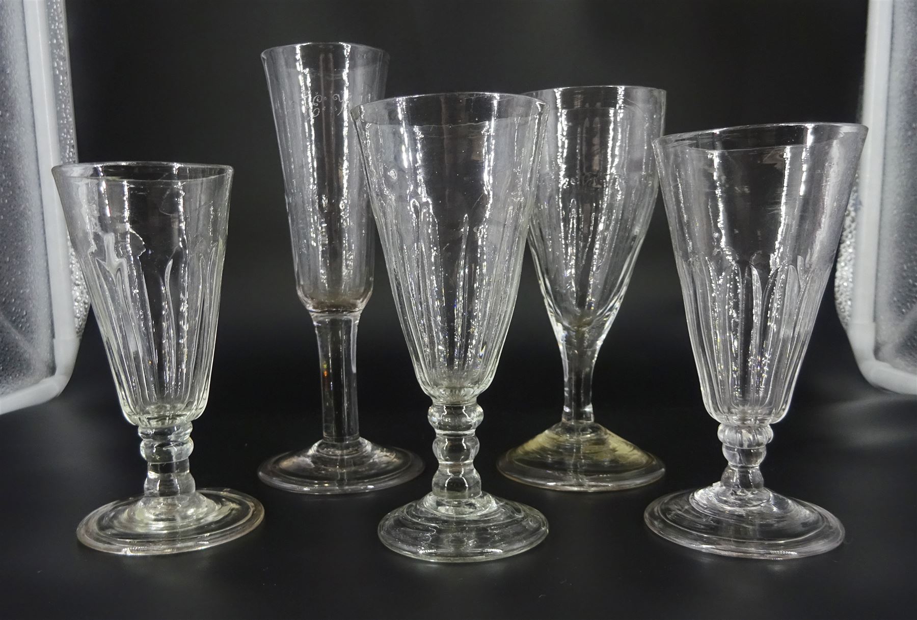 Five 18th century drinking glasses with part fluted bowls, to include a