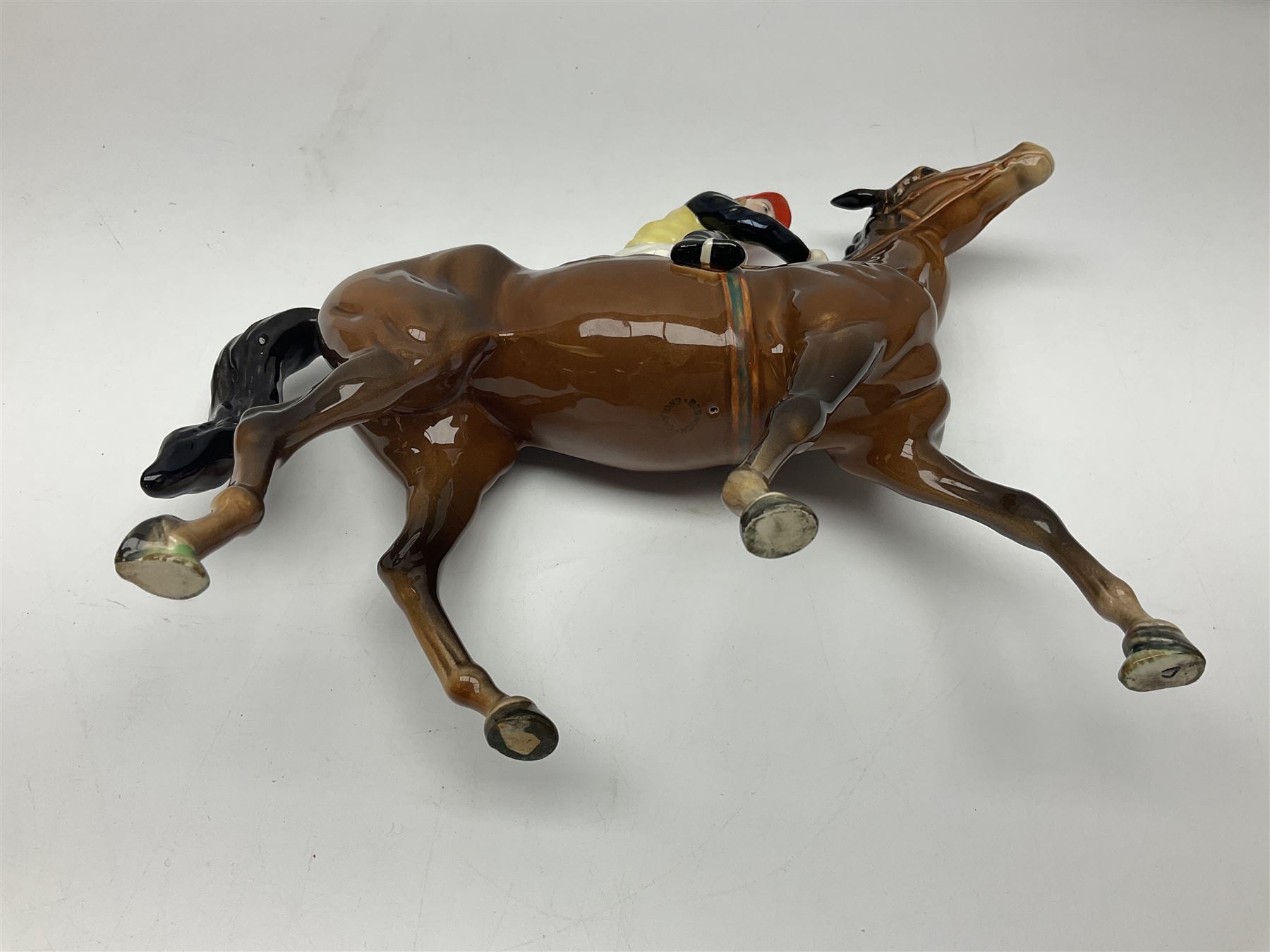 Beswick jockey on walking horse no 1037, in black white and yellow jockey colours, with printed mark beneath, H22cm