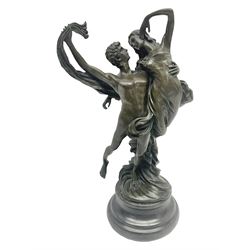 Bronze modeled as entwined dancers, upon a stepped circular base, H29cm