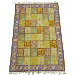  An Iranian lines silk tapestry wall hanging, the oblong centre divided into forty-eight small rectangular panels each with multicoloured floral decoration on various coloured grounds, within a purple ground border of stylised flowers W120cm L191cm Provenance: This lot was gifted to the vendor who worked for the Royal Family of Oman  