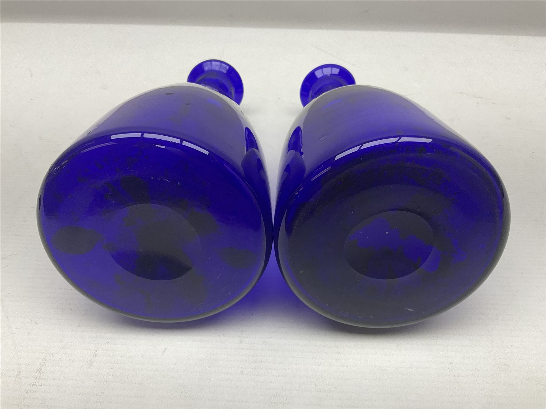 Pair of early 19th century blue glass decanters with teardrop stoppers, with gilt writing, the first marked Gin the second Brandy 