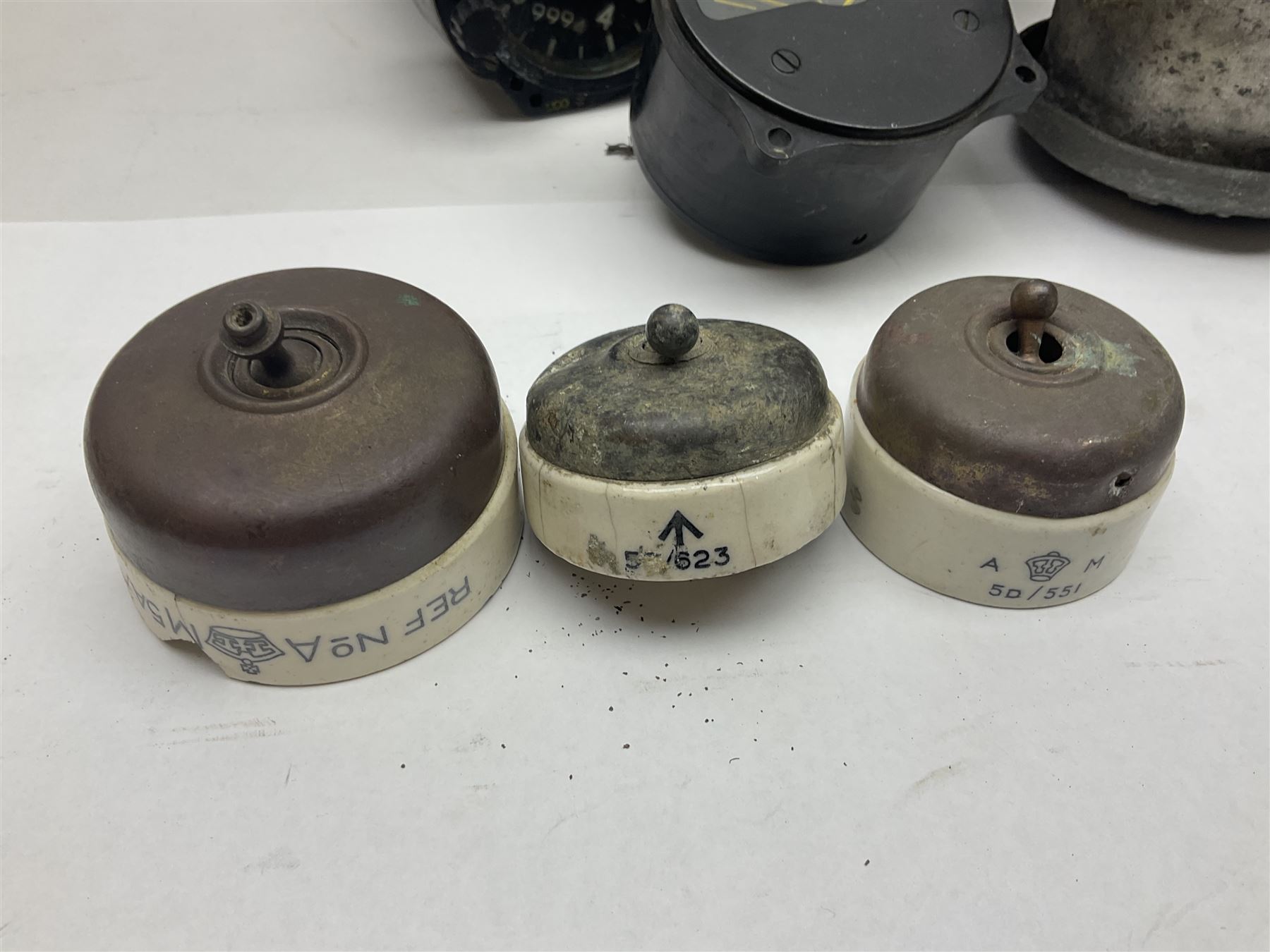 Three RAF light switches, together with military oxygen canister, batteries, gages etc  
