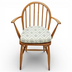 Ercol - elm dining chairs, a set of five comprising four side chairs and one '370' armchair, all with hoop backs formed with slender spindle splats, shaped solid elm seats, the armchair with curved out-swept arms, raised on splayed turned supports united by stretchers