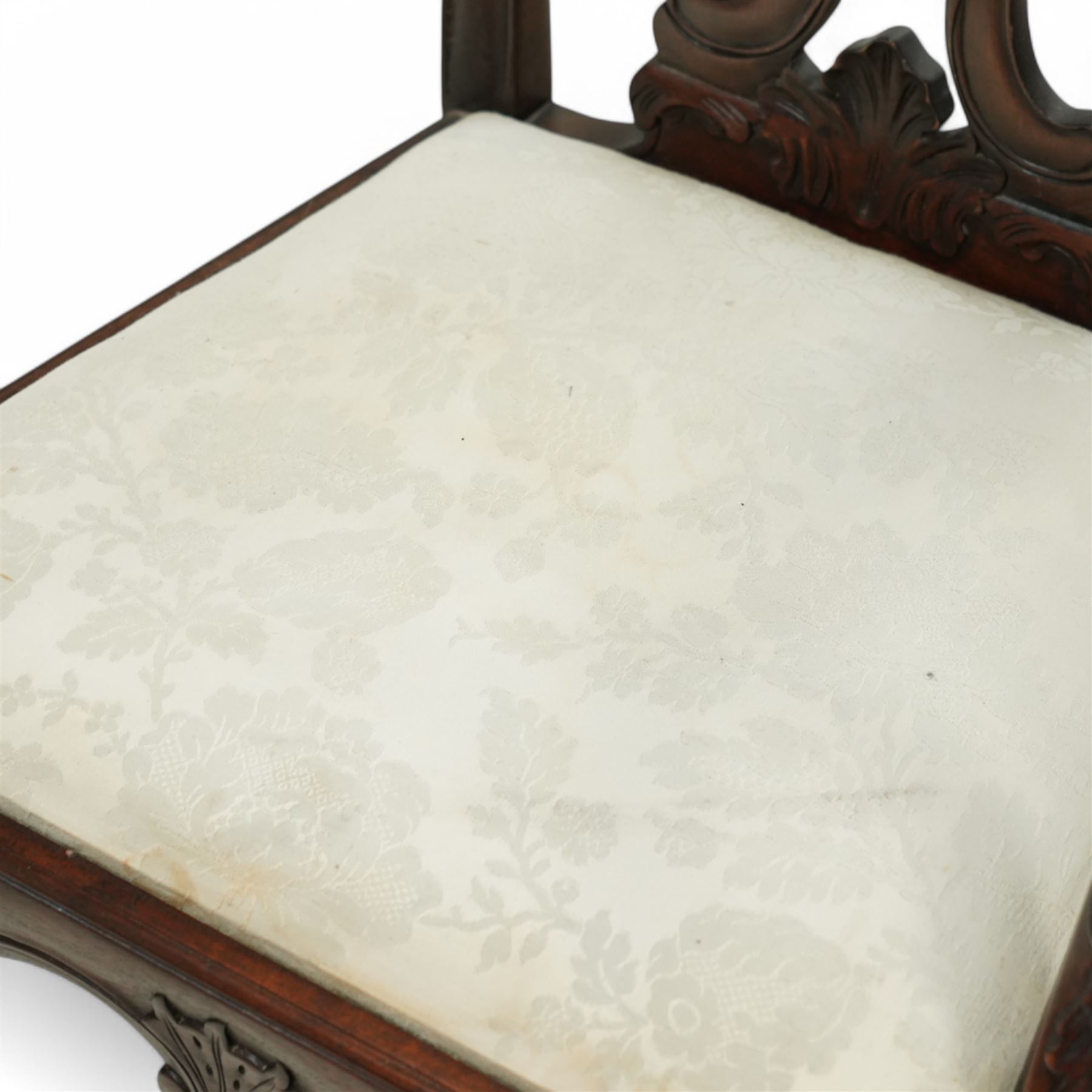 Chippendale revival mahogany dining chairs, set of six including a pair of carvers, the backs with intricately carved pierced splats beneath serpentine cresting rails, on acanthus carved cabriole front supports terminating in claw and ball feet, with cream upholstered drop-in seats