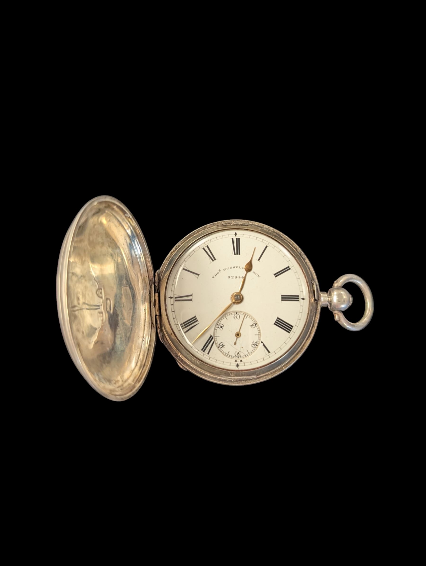Late Victorian silver full hunter pocket watch by Tho Russell & Son no. 82844, with white enamel dial and subsidiary seconds dial, the front cover with blank cartouche, hallmarked Chester 1891