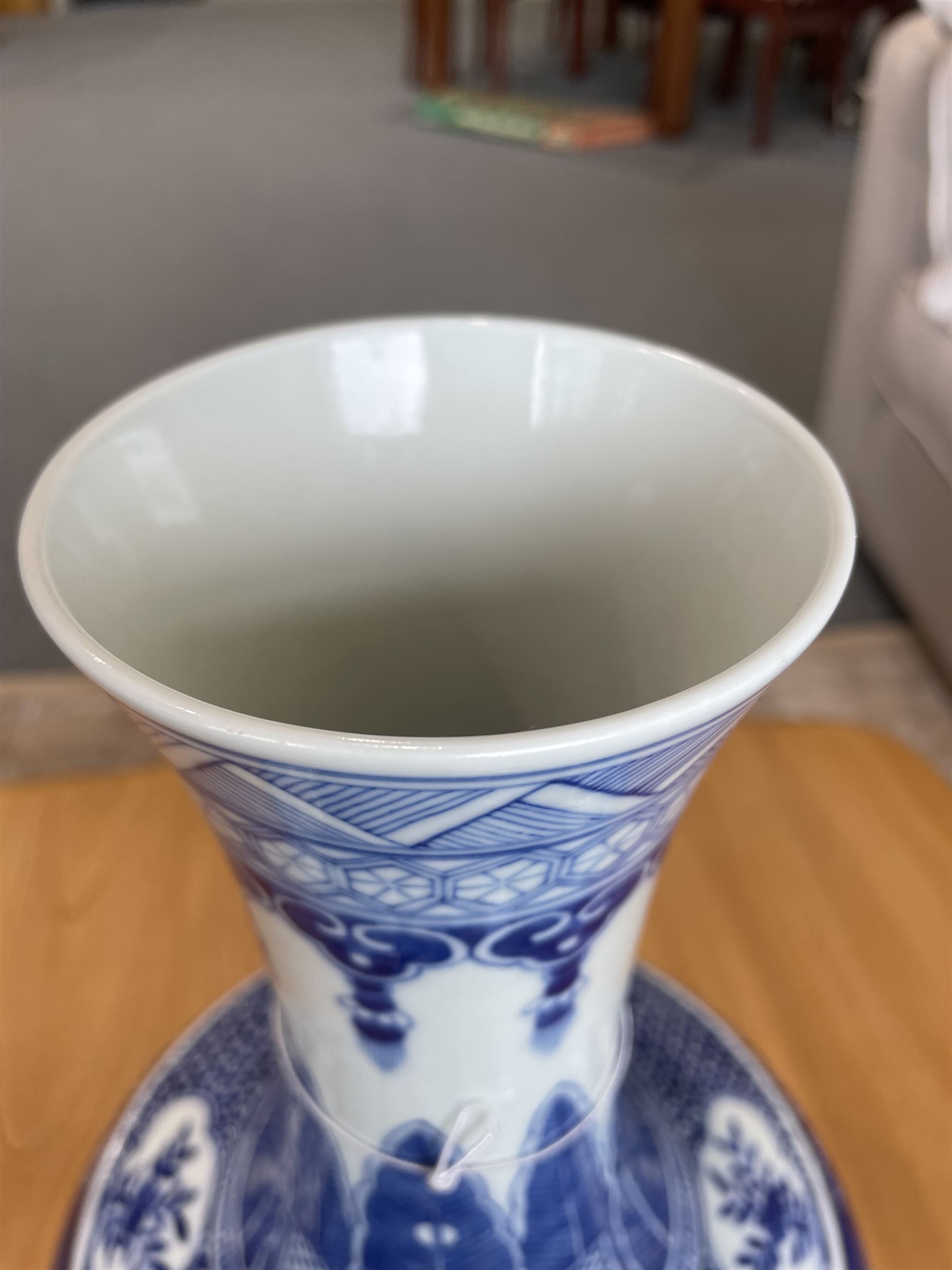 Late Qing Dynasty bottle vase decorated in blue and white with dragons and pearls, stylised leaves and flowers with key pattern foot H40cm 