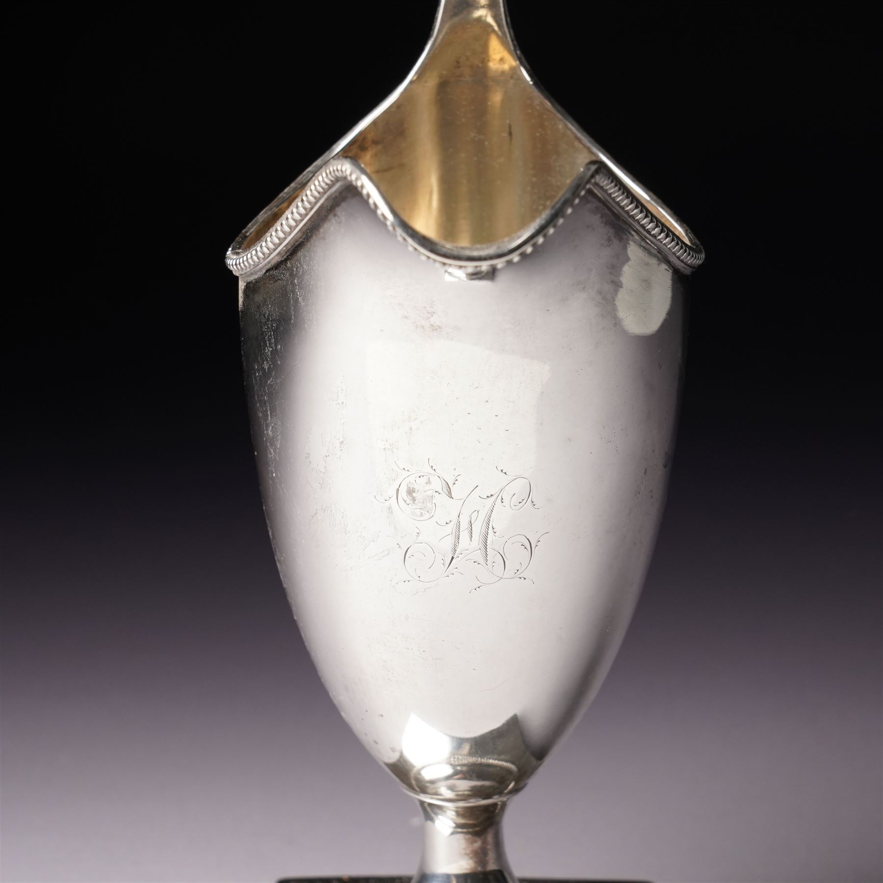 George III silver helmet shape cream jug engraved with a monogram with loop handle on square base H15cm London  1790 Maker Hester Bateman