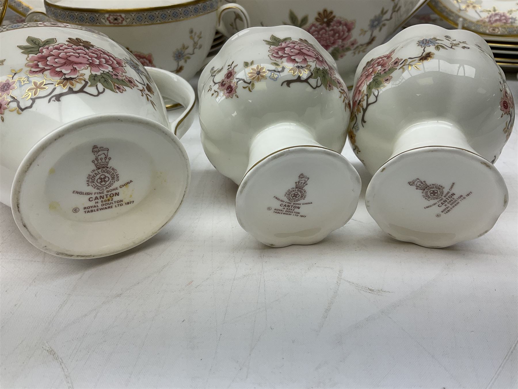Royal Doulton Canton pattern tea and dinner wares comprising teapot, milk jug, twin handled lidded sucrier, cake plate, six dinner plates, six side plates, five smaller plates, five saucers and pair of candlestick holders, together with Sevres clear glass decanter with faceted sides and stopper, all with marks beneath
