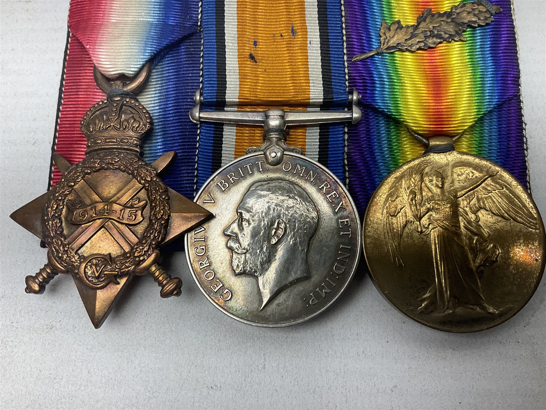 WW1 group of three medals comprising 1914-15 Star awarded to 536 Pte. T. Hall North'd Yeo. and British War Medal and Victory Medal with oak leaves awarded to 2.Lieut. T. Hall; with ribbons; displayed on board for wearing; some biographical details
