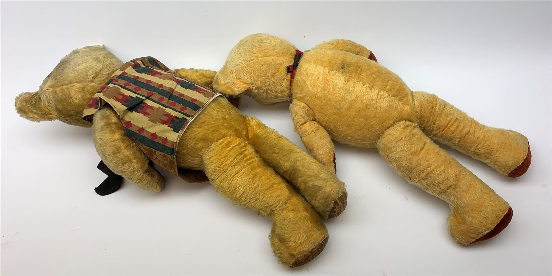 1950s English large wood wool filled teddy bear with swivel jointed head, glass type eyes and vertically stitched nose and mouth and jointed limbs with rexine paw pads H33