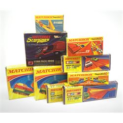 Collection of Matchbox Superfast track comprising two x SF-17 Slipstream curves, Scorpions Sting Pack 3000, TA-6 Catapult Pass, TA-7 Dare Devil Switch, TA-4 Pacemaker Hand Booster, SF-19 Double Action Opening Garage, SF-16 Grand Prix Pack and SF-12 Loop Pack; all boxed; SF-13 Space Leap and ten track lengths with connectors, unboxed (10)