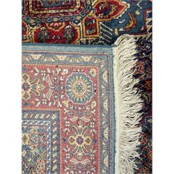 Persian design blue ground rug, the field decorated with Herati motifs and central floral medallion, repeating guarded border decorate with flower heads and trailing leafy branches 